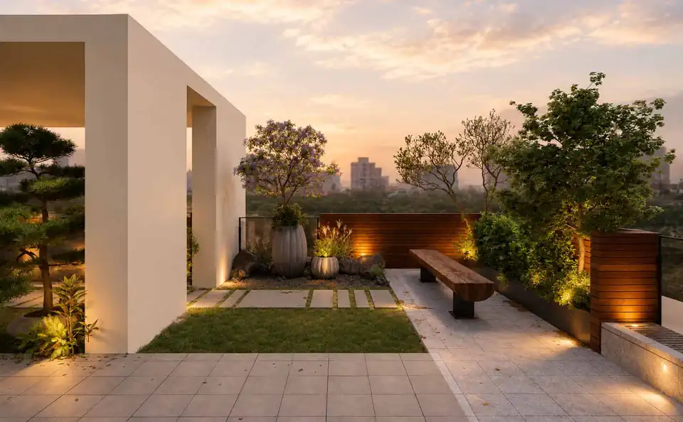 A planted roof garden at sunset, with the township skyline beyond the parapet
